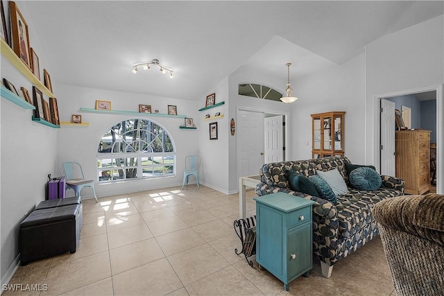 living room featuring lofted ceiling and light tile patterned floors