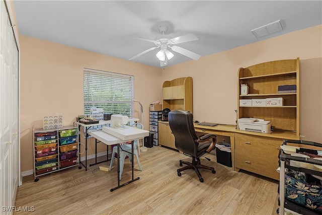 office with ceiling fan and light hardwood / wood-style floors