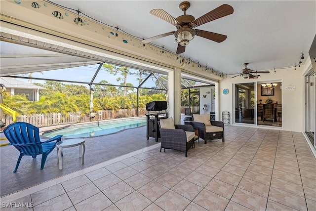 view of patio featuring a fenced in pool, grilling area, ceiling fan, and glass enclosure