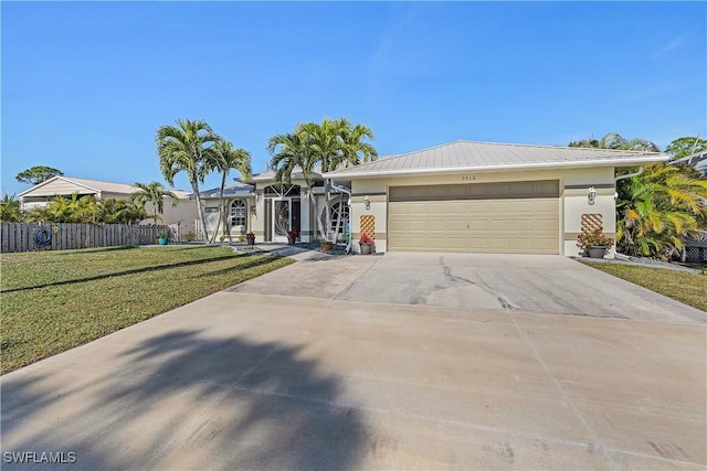 ranch-style house featuring a garage and a front yard