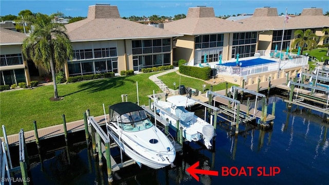 view of dock featuring a water view and a lawn