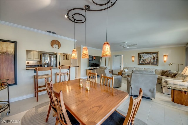 tiled dining room featuring ceiling fan and ornamental molding