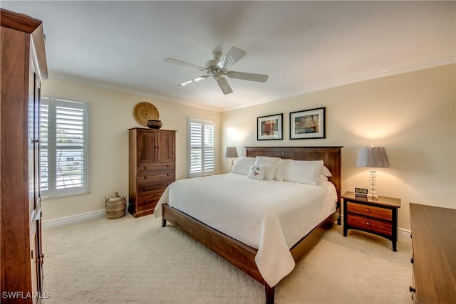 carpeted bedroom with crown molding and ceiling fan