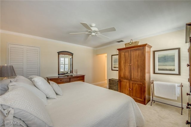 carpeted bedroom with ornamental molding, a closet, and ceiling fan