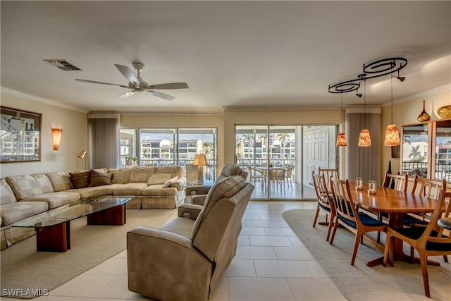 tiled living room with ornamental molding and ceiling fan