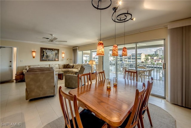 dining area featuring crown molding, ceiling fan, and light tile patterned flooring