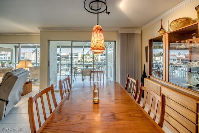 dining area with light tile patterned flooring and ornamental molding