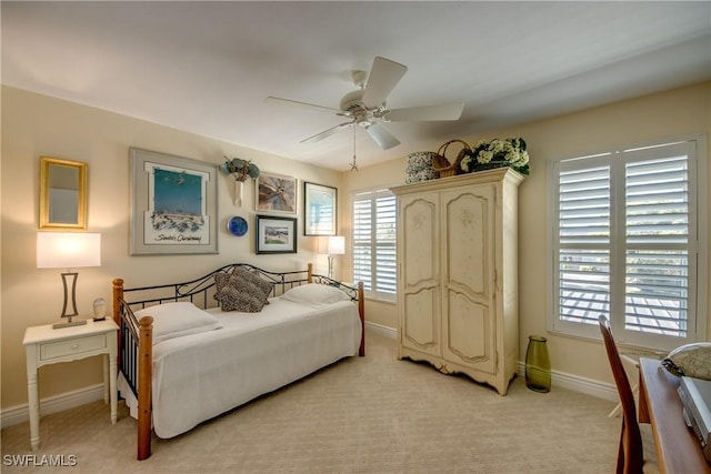 bedroom featuring ceiling fan and light carpet