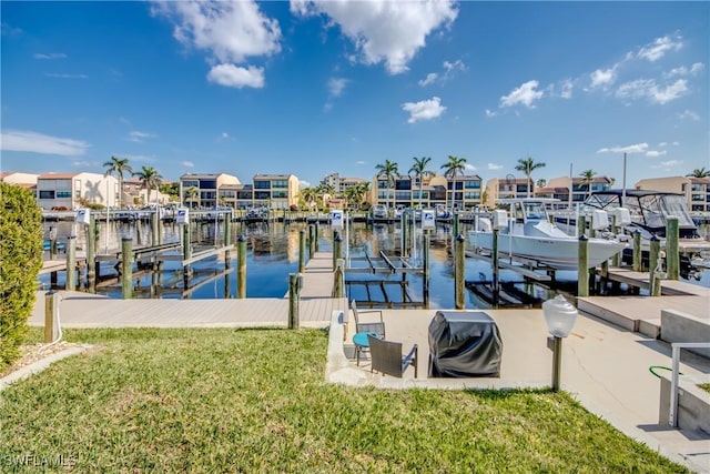 dock area featuring a water view and a lawn