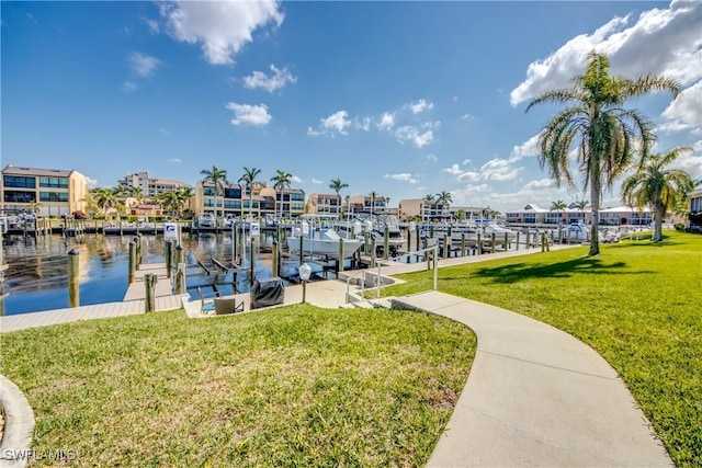 view of dock with a water view and a yard