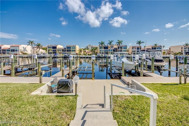 view of dock with a water view and a lawn