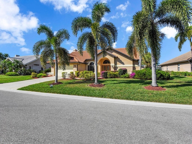 view of front of house featuring a garage and a front yard