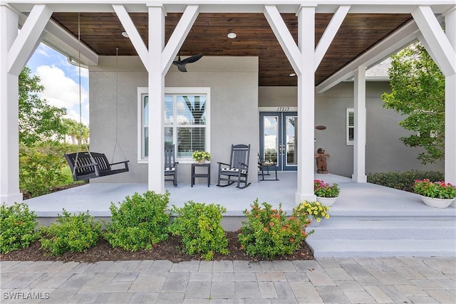 view of patio with french doors, ceiling fan, and a porch