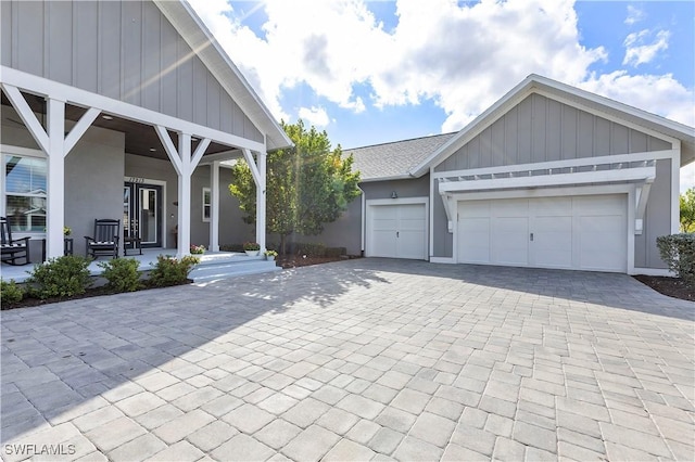 exterior space featuring a garage and covered porch