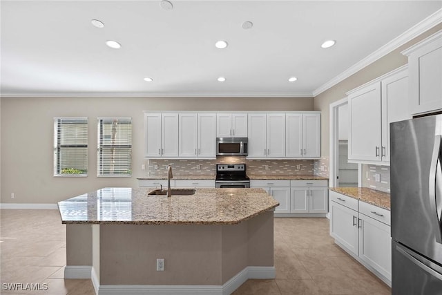 kitchen featuring light stone counters, stainless steel appliances, a sink, ornamental molding, and decorative backsplash