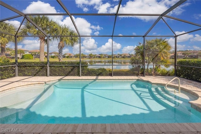 view of swimming pool featuring glass enclosure and a water view