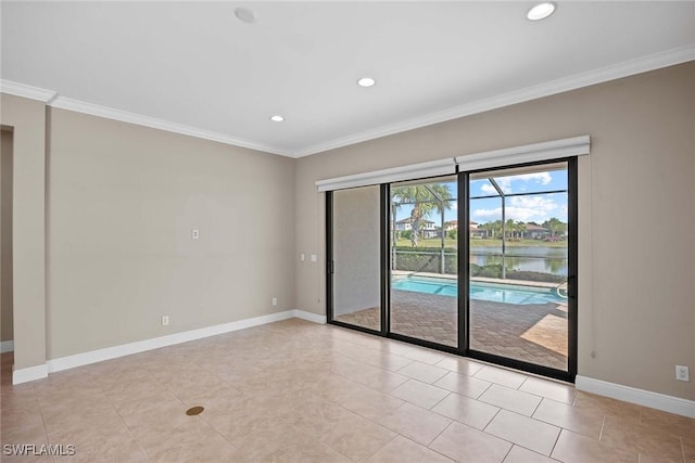 spare room with ornamental molding, recessed lighting, and baseboards