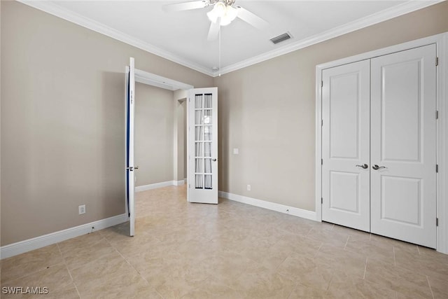 unfurnished bedroom with visible vents, baseboards, french doors, a closet, and crown molding