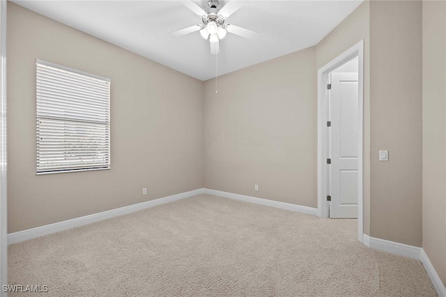 unfurnished room with carpet, baseboards, and ceiling fan