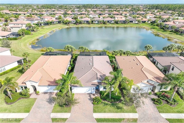 drone / aerial view featuring a residential view and a water view