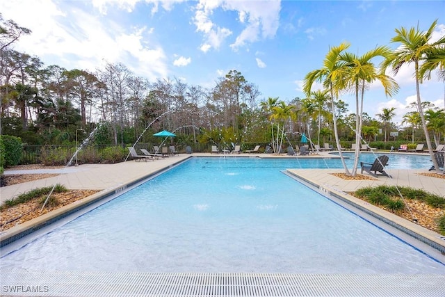 pool featuring fence and a patio