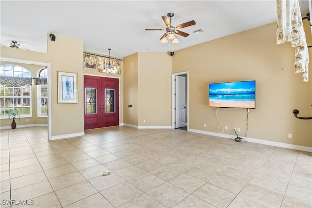 unfurnished living room featuring ceiling fan and light tile patterned flooring