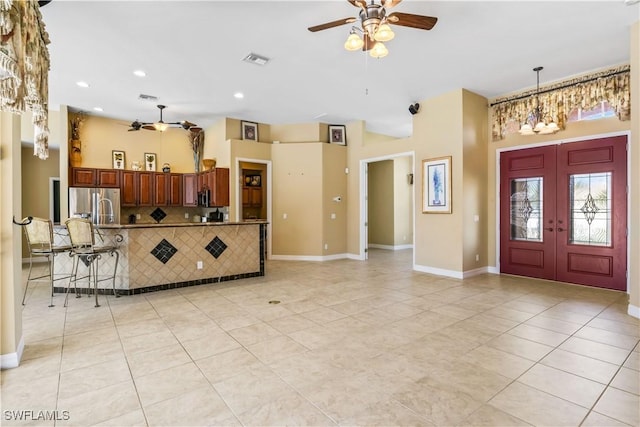 entryway featuring french doors, ceiling fan, and light tile patterned floors