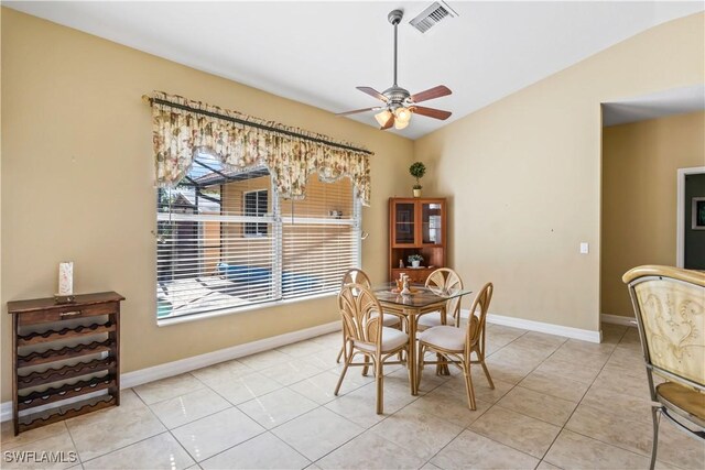 dining area with light tile patterned flooring, lofted ceiling, and ceiling fan