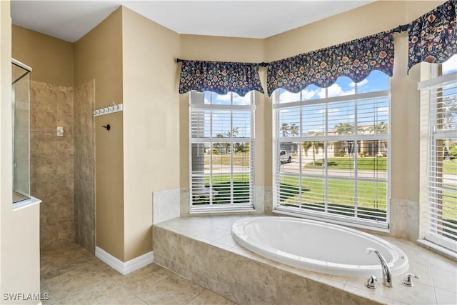 bathroom with tile patterned flooring, shower with separate bathtub, and plenty of natural light