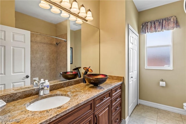 bathroom featuring tile patterned flooring, vanity, and toilet