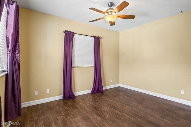 empty room featuring dark hardwood / wood-style floors and ceiling fan