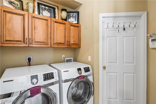 laundry area featuring cabinets and washer and dryer