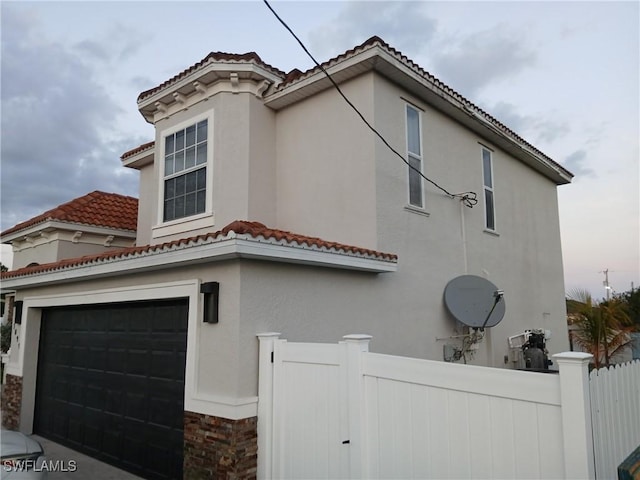 view of side of property featuring a garage