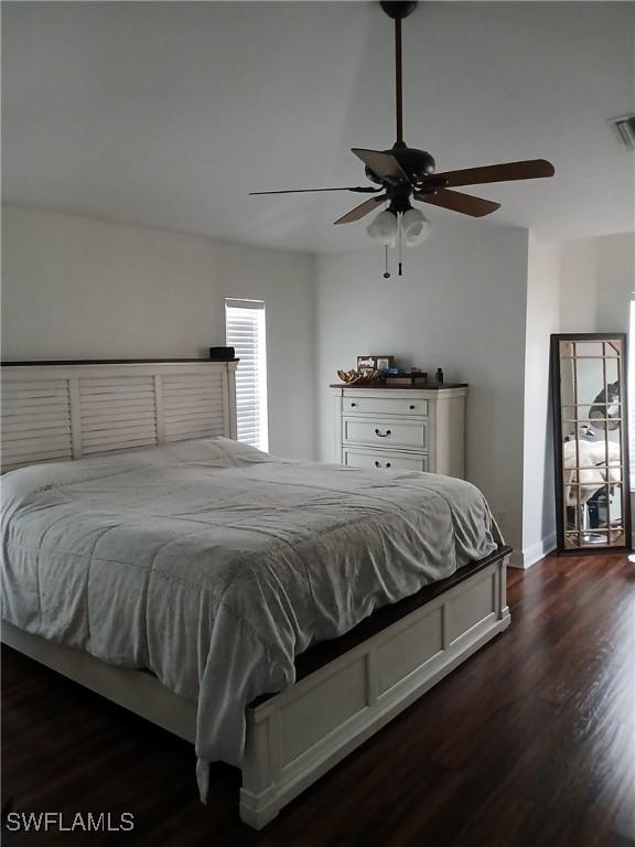 bedroom with ceiling fan and dark hardwood / wood-style floors