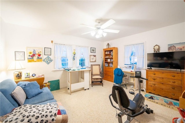 exercise room with ceiling fan