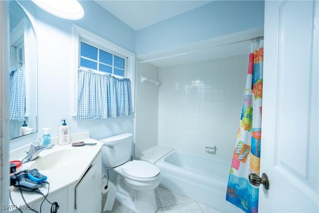 full bathroom with shower / tub combo with curtain, vanity, tile patterned floors, and toilet