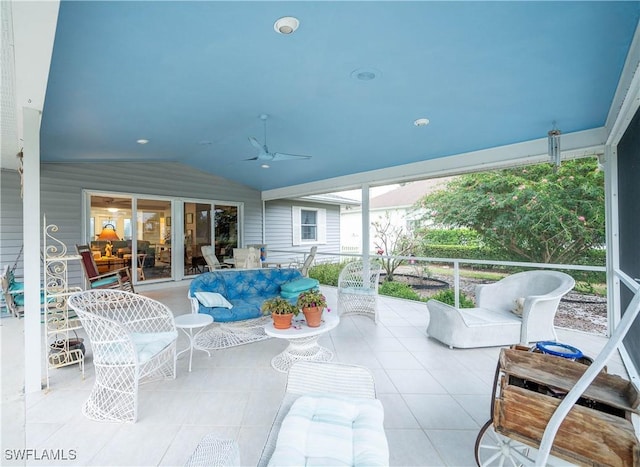 sunroom featuring lofted ceiling and ceiling fan