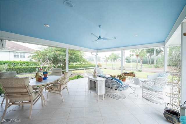 sunroom featuring ceiling fan