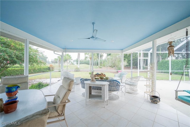 sunroom / solarium featuring ceiling fan