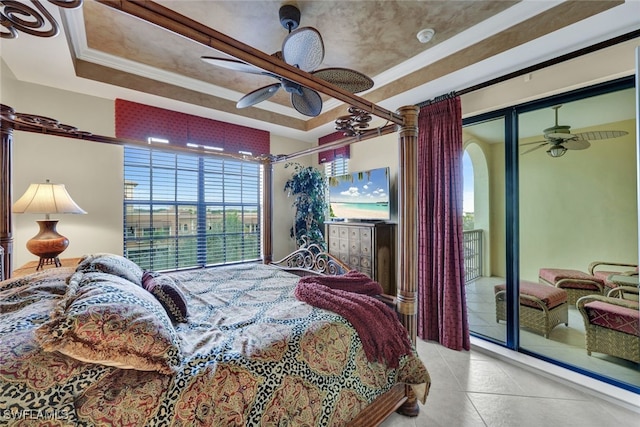 tiled bedroom featuring a tray ceiling