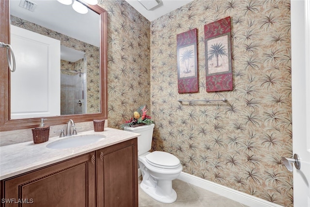 bathroom with vanity, tile patterned floors, and toilet