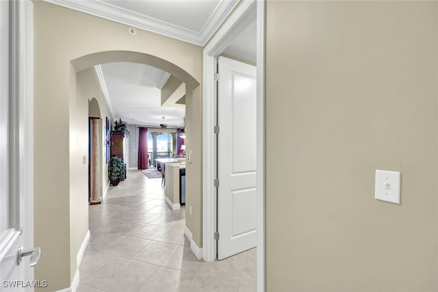 hallway with light tile patterned floors and ornamental molding