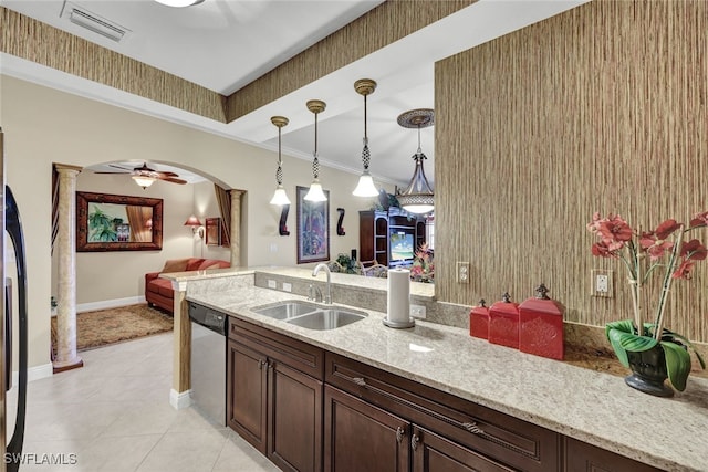 kitchen with appliances with stainless steel finishes, sink, ornamental molding, dark brown cabinetry, and light stone countertops