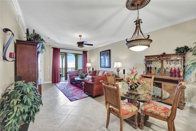 tiled dining area with ornamental molding and ceiling fan