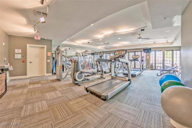 workout area featuring light carpet and ceiling fan