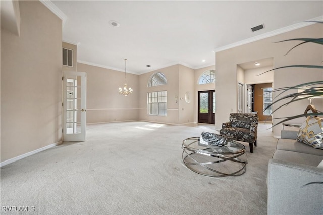 carpeted living room with french doors, crown molding, and an inviting chandelier