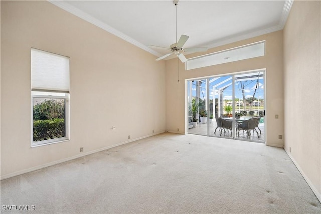 carpeted spare room with crown molding and ceiling fan