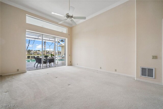 spare room with carpet floors, a sunroom, visible vents, and baseboards