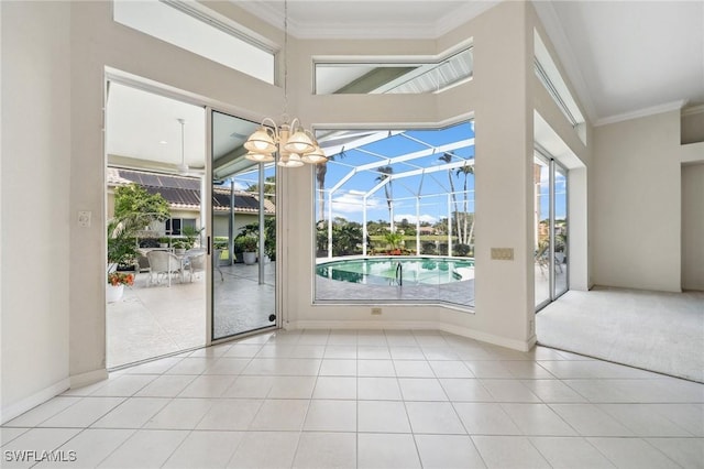 doorway to outside featuring ornamental molding, light tile patterned flooring, a sunroom, and baseboards