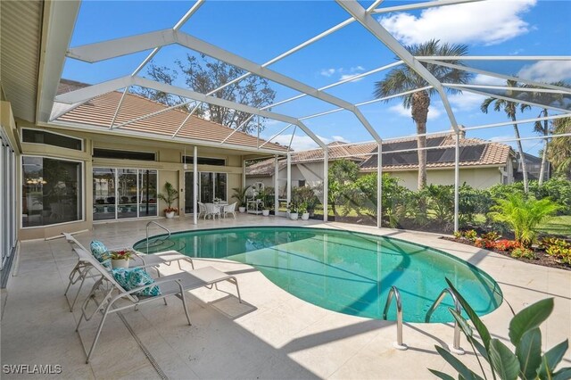 view of pool with a lanai and a patio area